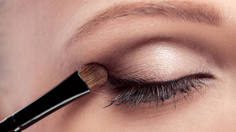 A woman applying eyeshadow