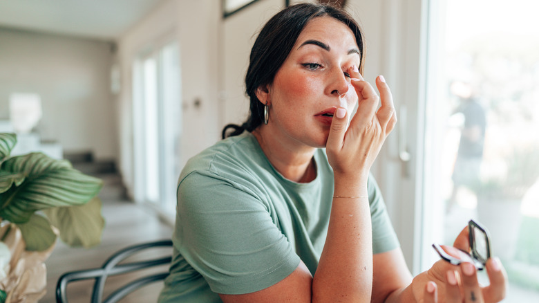 A woman applying eyeshadow