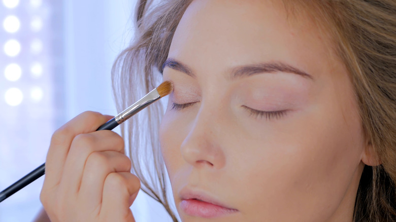 A woman applying eyeshadow