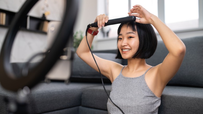 Woman curling her hair