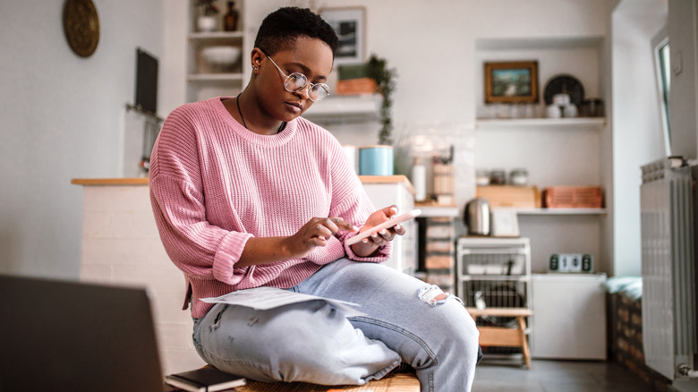 Person managing finances on phone