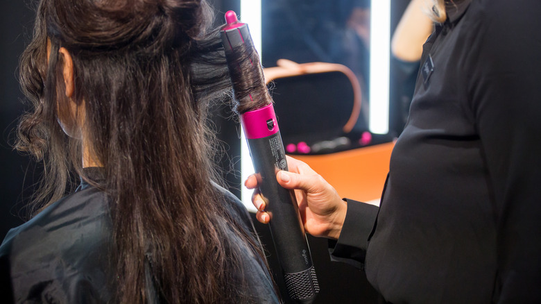 hairstylist using Dyson Airwrap