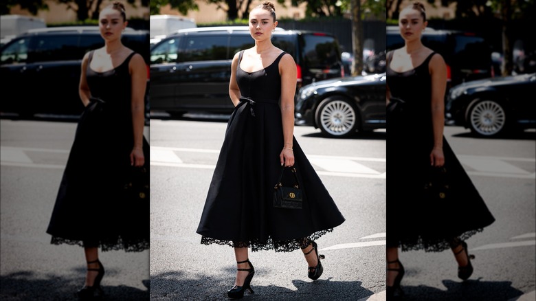 Margo Hayes in black A-line skirt and tank top