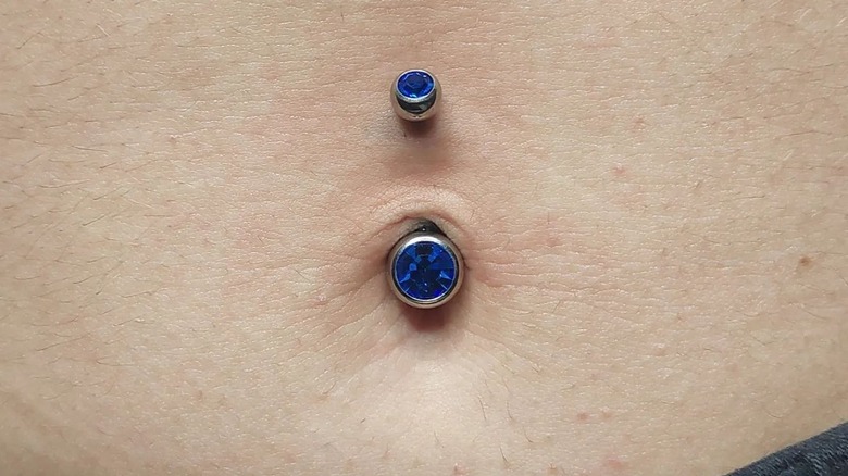 Blue belly button piercing
