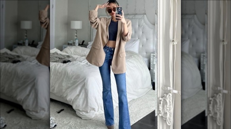 Woman wearing black ribbed tank under blazer