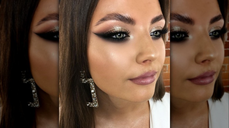 Woman wearing smudged black wing