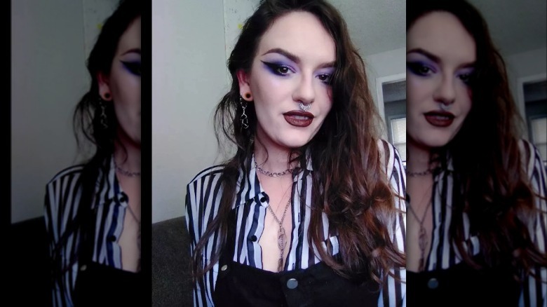 Woman wearing smoky purple cat eye 