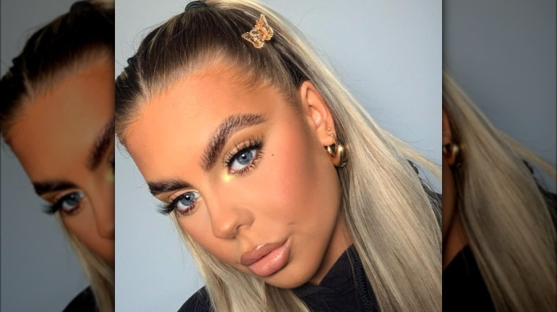 Young women models makeup look with gold inner corner highlight