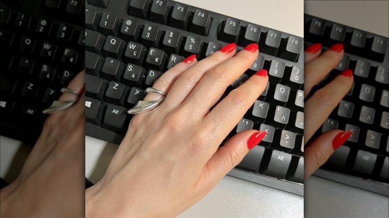 hand with a pinky ring