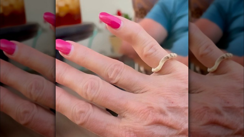 hand with a pinky ring