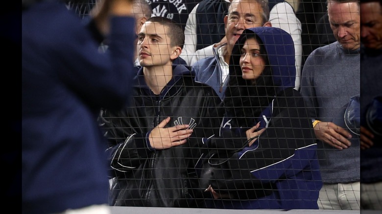 Timothée Chalamet and Kylie Jenner putting their hands on their hearts