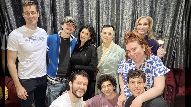 Timothée Chalamet and Kylie Jenner posing backstage with Broadway performers
