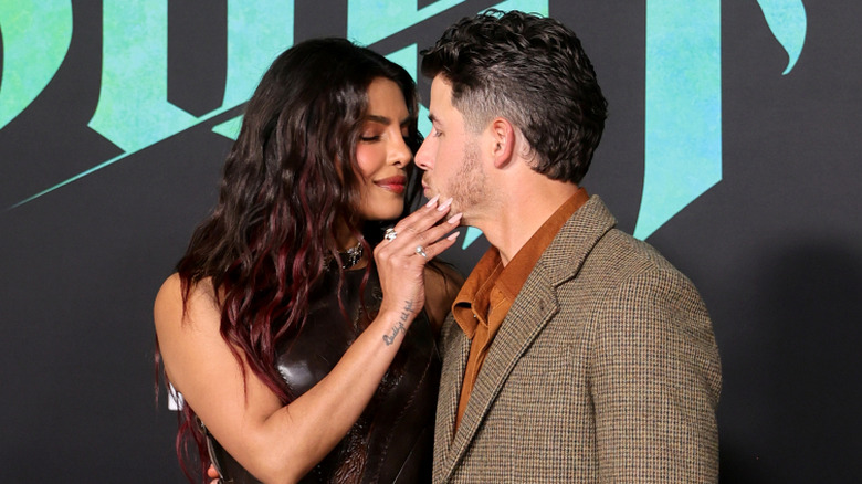 Priyanka Chopra and Nick Jonas lean in for a kiss while at a movie premiere