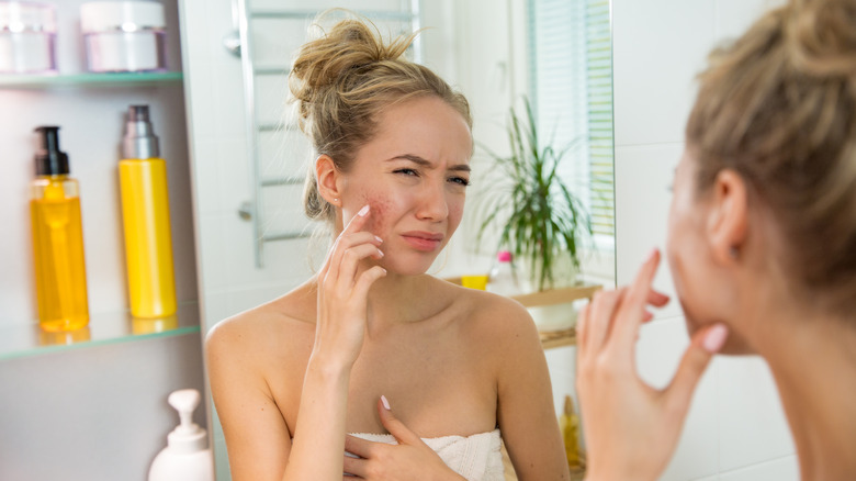 Woman with painful pimples