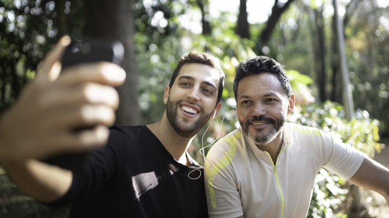 Couple taking selfie in park