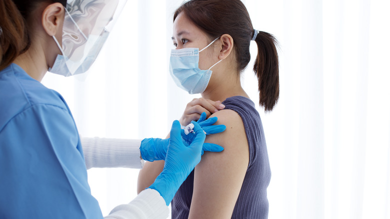 young woman receiving vaccine