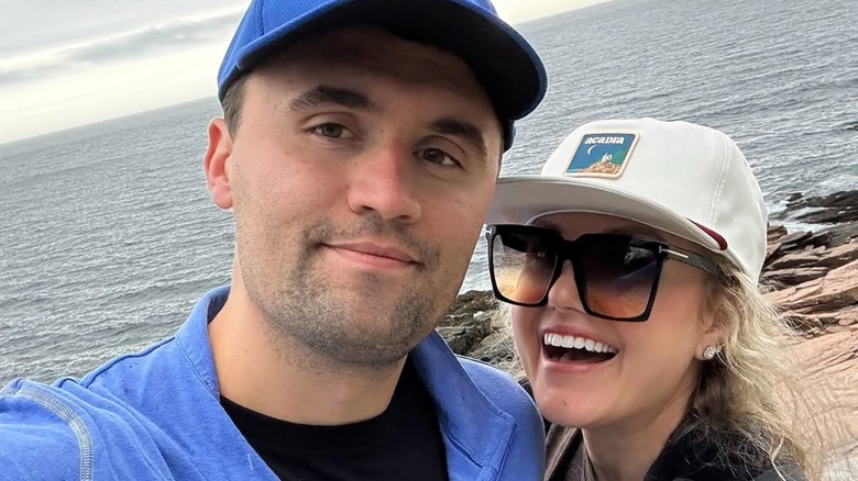 Selfie of Charlie Kirk and Erika Kirk smiling in front of body of water