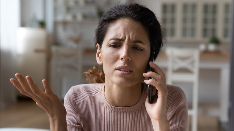 Worried woman talking on the phone