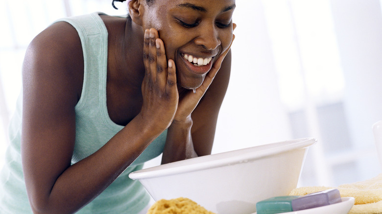 Woman washing her face
