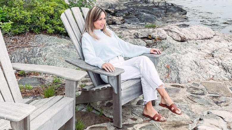 woman sitting on chair near beach