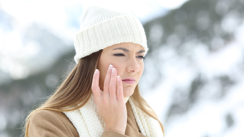 Woman touching her face