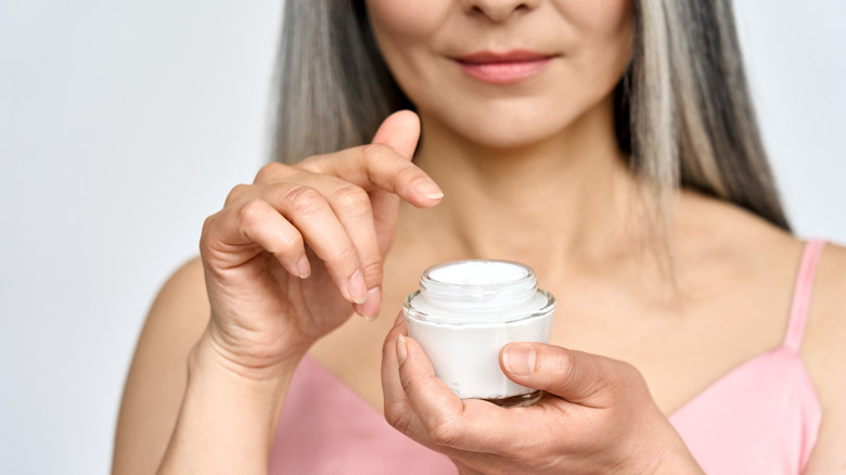 mature woman holding cream