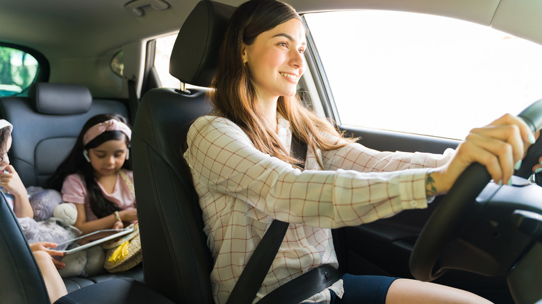 Kids use tablets in mini-van