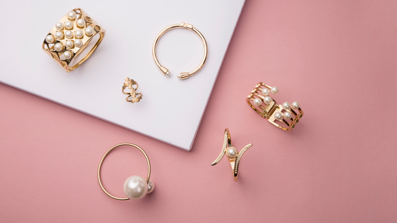 pieces of gold jewelry laying down