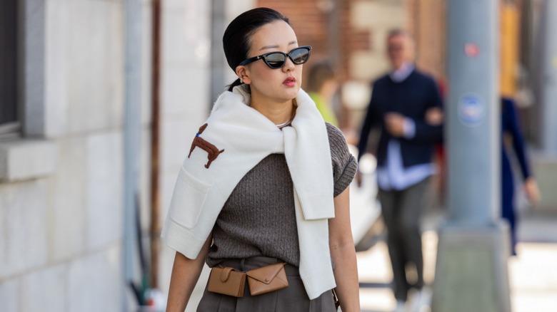 woman wearing sweater around shoulders