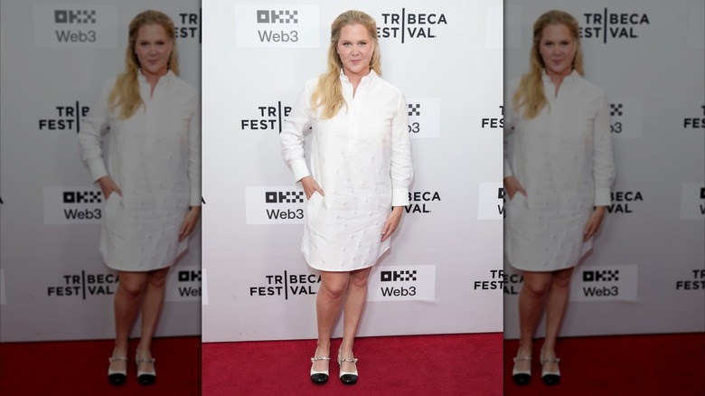 Amy Schumer in a white shirtdress