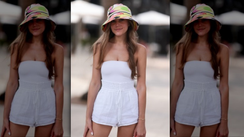 woman wearing a white tube top and cotton shorts