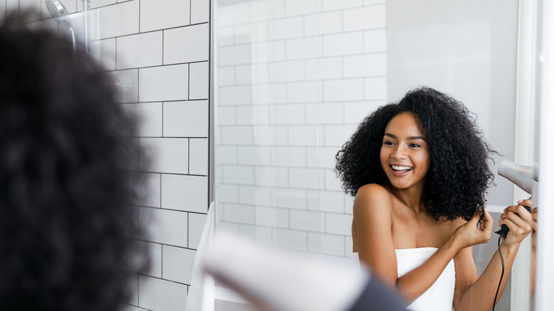 woman using hair dryer