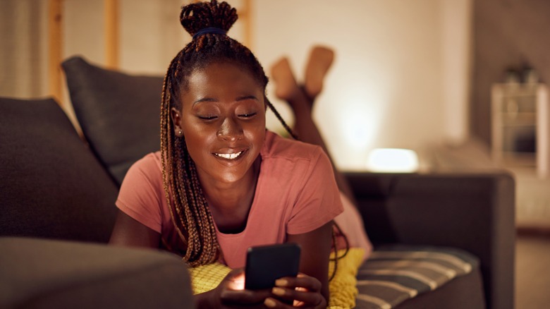 smiling woman texting on phone