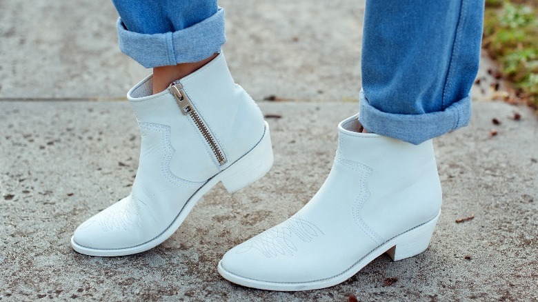 White cowboy boots and cuffed jeans 