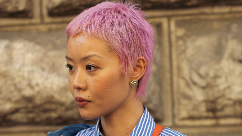 A person with a pink  pixie cut