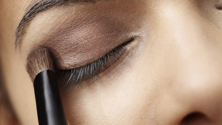 woman applying eyeshadow