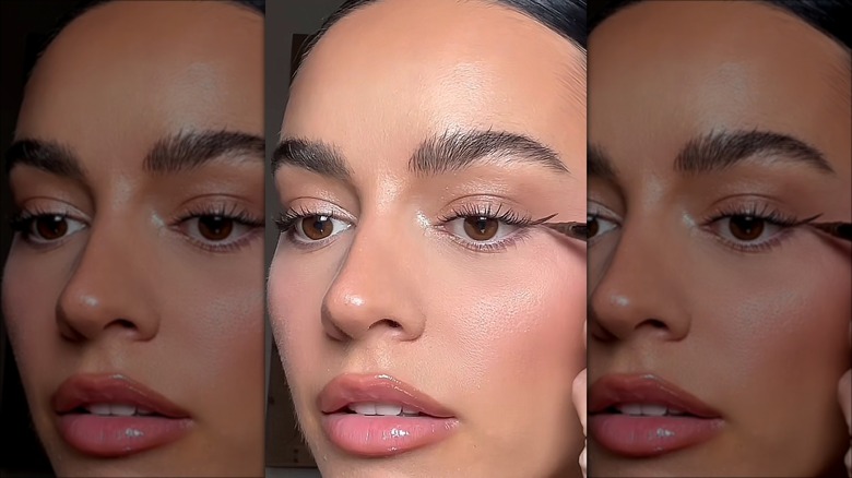 woman applying eyeliner