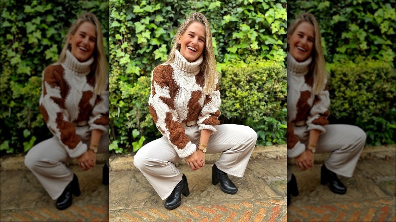 Woman posing in animal-print sweater