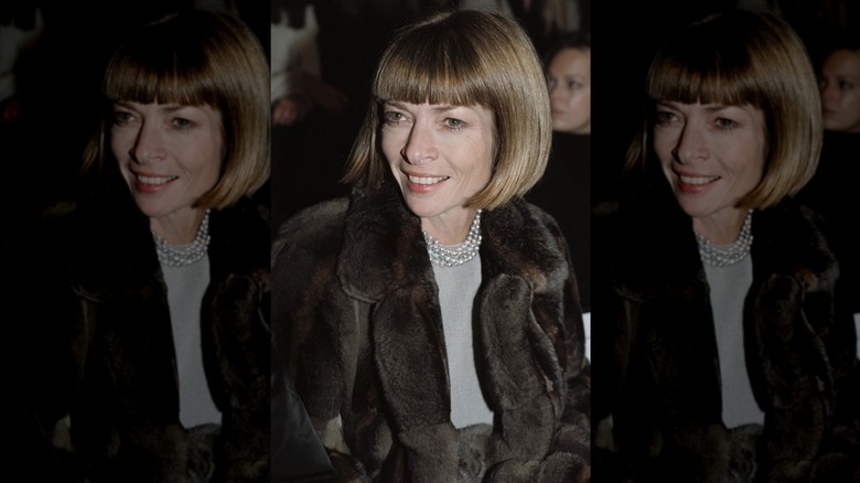Anna Wintour smiles with honey-blonde hair wearing a fur jacket and a pearl necklace