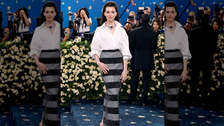 Anne Hathaway wears a white shirt and long black-and-gray skirt at the 2025 Met Gala