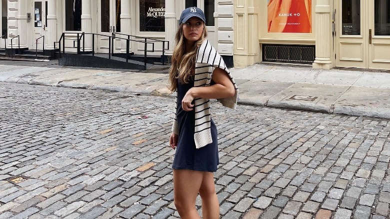 woman wearing exercise dress and sweater