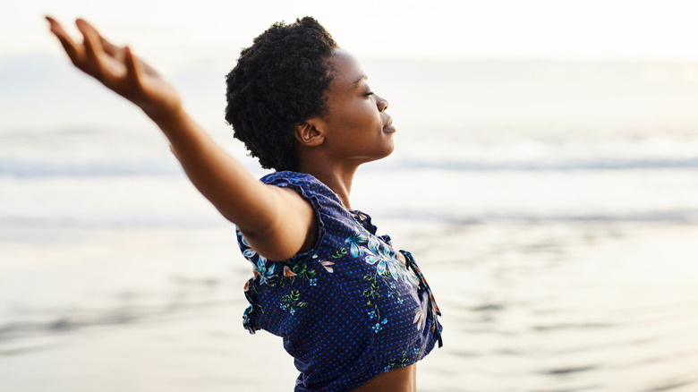 person with arms out