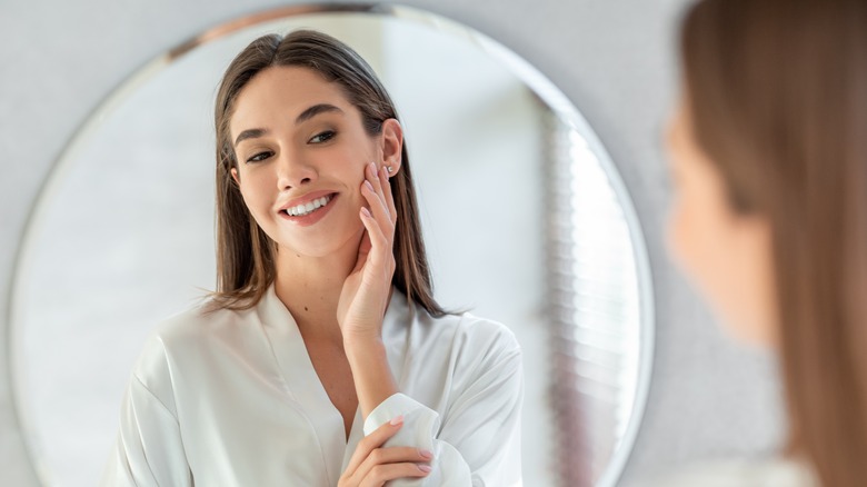 Woman admires her skin