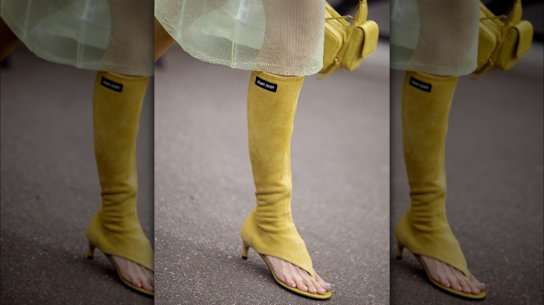 Person in yellow thong boots