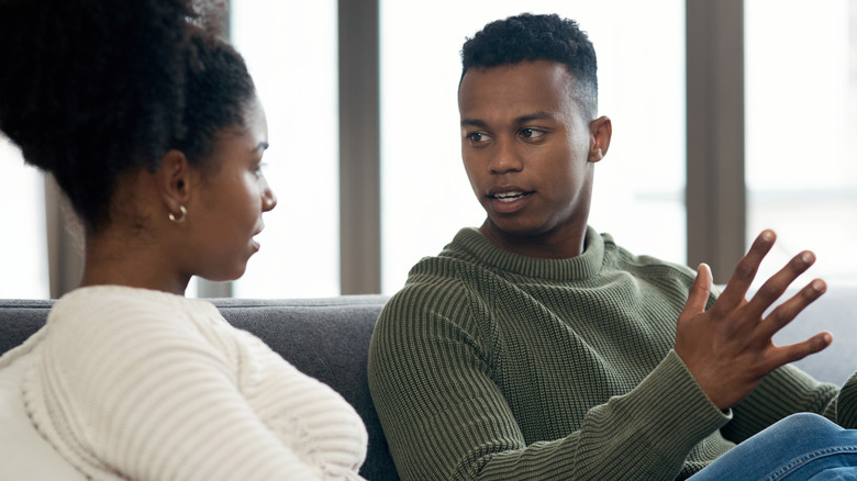 couple talking on sofa