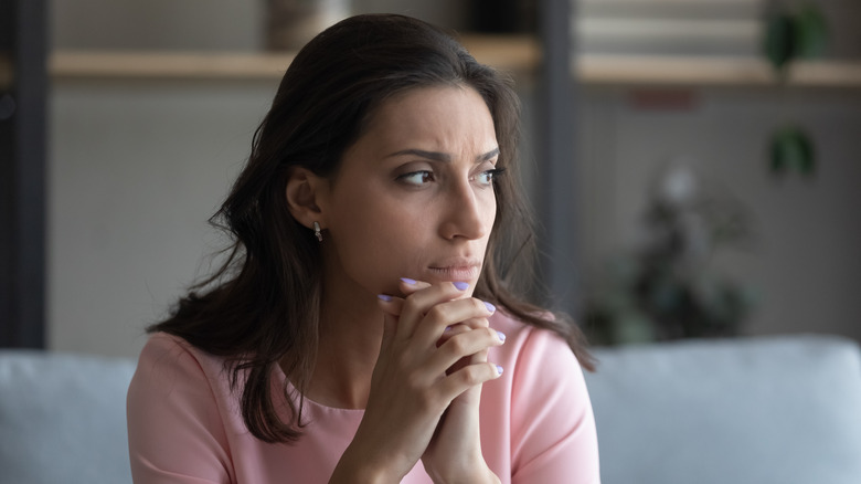 Woman thinking on couch
