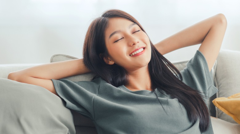 Asian woman relaxing on sofa