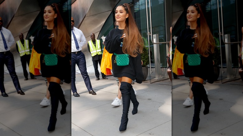 Ariana Grande in an oversized hoodie with boots