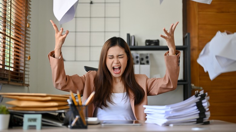 woman yelling and throwing papers