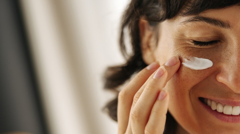 woman applying arnica cream